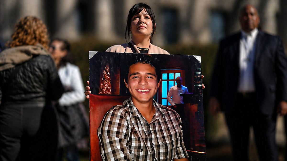 AI illustration of Manuel Esteban Paez Terán's mother holding up a photo of him